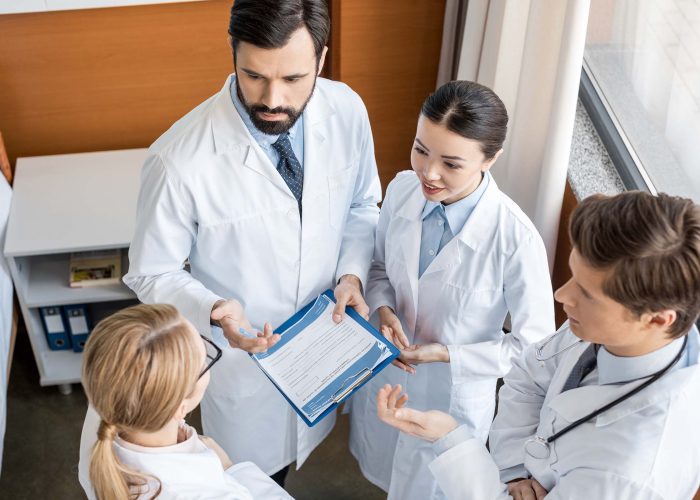 elevated-view-of-doctors-team-discussing-diagnosis-GVY6VNT.jpg